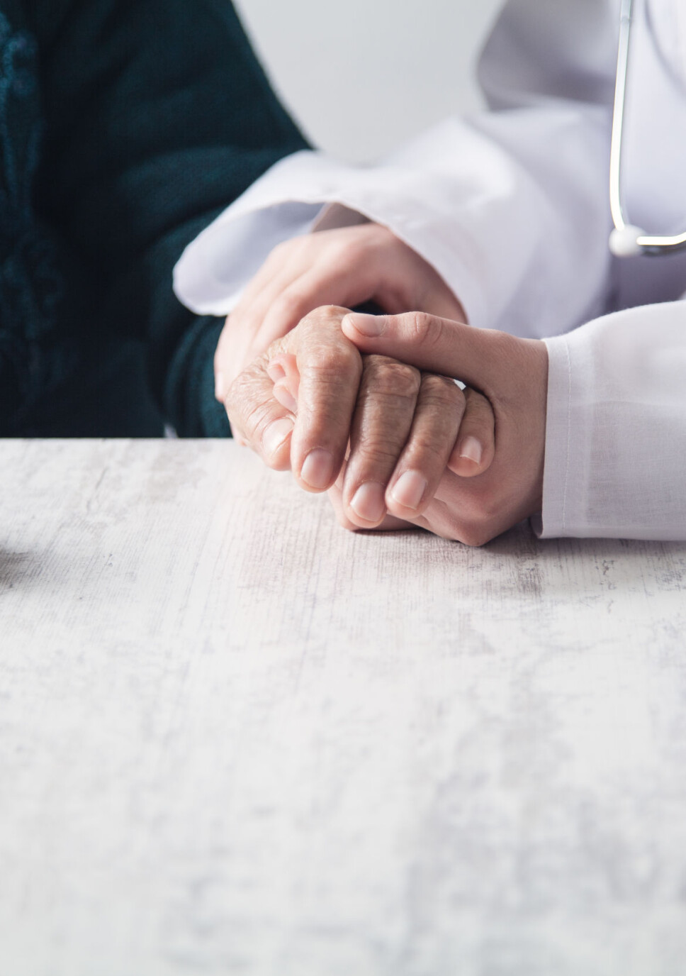 Doctor holding patient hands in hospital. Patient care